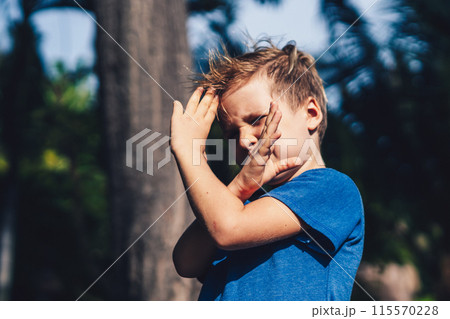 Child boy blue t-shirt karate pose, playing outside summer day. Happy childhood, family education Child boy blue t-shirt karate pose, playing outside summer day. Happy childhood, family education 115570228