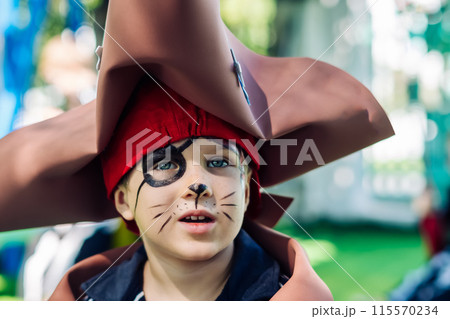 Boy Cat Pirate costume. Halloween party in kindergarten. Aqua makeup painted kids face. Bright festive 115570234