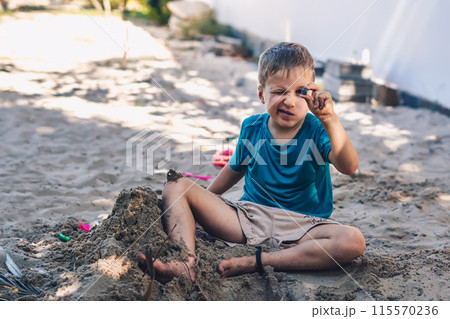 Child playing in sandbox. Happy childhood freedom creativity development, tactile Nature sensations Child playing in sandbox. Happy childhood freedom creativity development, tactile Nature sensations 115570236