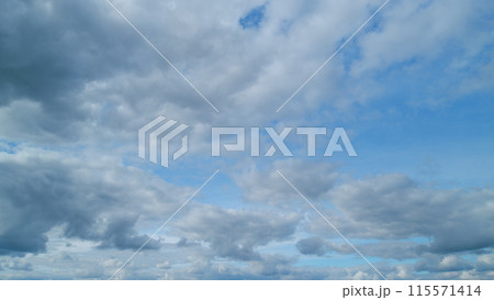 Cloud sky scape. Clouds flying and changing with different shapes on clear blue sky. Timelapse. 115571414