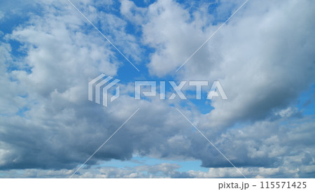 Fluffy curly rolling cloud in windy summer weather. White clouds background. Timelapse. 115571425