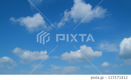 Sky with bautiful silky clouds. Puffy fluffy cumulus and cirrus on different layers clouds. Timelapse. 115571812