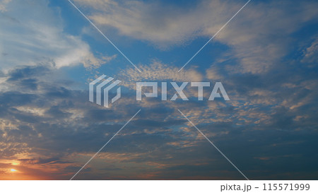 Sunset with clouds in motion. Summer sky at sunset with cirrocumulus clouds. Timelapse. Sunset with clouds in motion. Summer sky at sunset with cirrocumulus clouds. Timelapse. 115571999