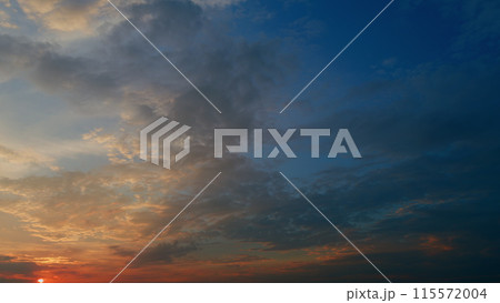 Different shades colored cirrus clouds during sunset. Only sky above horizon. Timelapse. 115572004