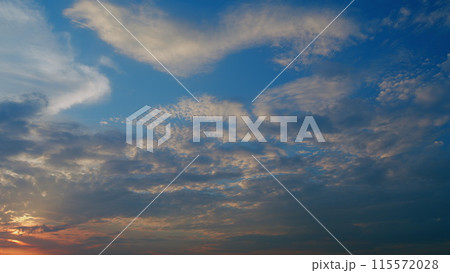 Texture of bright evening sky during sunset. Background of cirrus clouds on burning dawn. Timelapse. 115572028