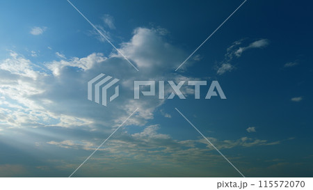 Building of a large white cloud in the blue sky. Clouds moving in blue sky with sun rays. Timelapse. Building of a large white cloud in the blue sky. Clouds moving in blue sky with sun rays. Timelapse. 115572070