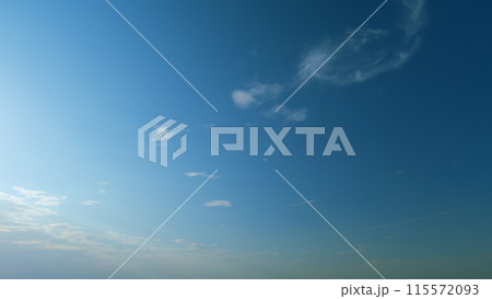 Beautiful scenic blue sky with rays of sun shining through clouds. Sun rays. Timelapse. 115572093
