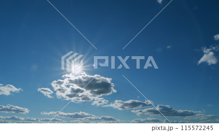 Cloudscape in tropical summer or spring sunlight. Beautiful sun rays shine through the clouds creating peaceful atmosphere. Timelapse. 115572245