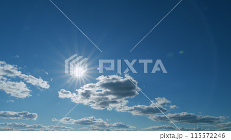 Beautiful cloudscape with large, building clouds. Suns rays shine through the cloud. Timelapse. 115572246