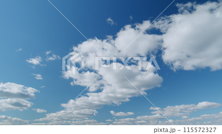 White clouds float across the blue sky. Puffy fluffy soft clouds. Timelapse. White clouds float across the blue sky. Puffy fluffy soft clouds. Timelapse. 115572327