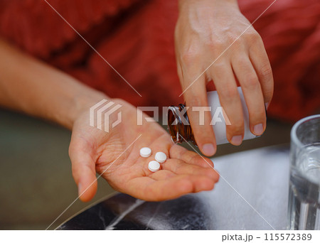 adult sick ill man hold pills on hand pouring capsules from medication bottle, take painkiller supplement medicine, people pharmaceutical healthcare treatment concept, close up view at home 115572389