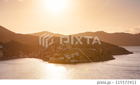 Symi Island, Greece. Greece islands holidays from Rhodos in Aegean Sea. Colorful neoclassical houses in bay of Symi. view of main bay of island, where tourist ferries and yachts moor Symi Island, Greece. Greece islands holidays from Rhodos in Aegean Sea. Colorful neoclassical houses in bay of Symi. view of main bay of island, where tourist ferries and yachts moor 115572411