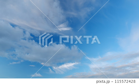 Cirrus clouds flying slowly on beautiful blue sky horizon background. Timelapse. Cirrus clouds flying slowly on beautiful blue sky horizon background. Timelapse. 115572428
