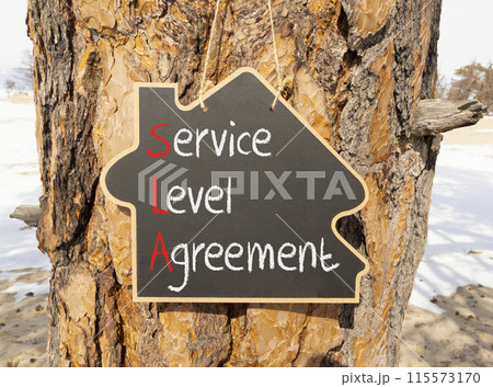 SLA service level agreement symbol. Concept words SLA service level agreement on beautiful yellow blackboard. Beautiful tree wooden background. Business SLA service level agreement concept. Copy space 115573170