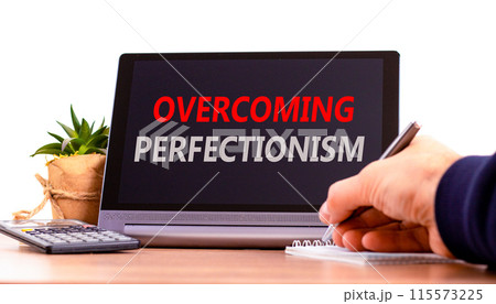 Overcoming perfectionism symbol. Concept words Overcoming perfectionism on beautiful black pad. Beautiful white background. Businessman hand. Business Overcoming perfectionism concept. Copy space. 115573225