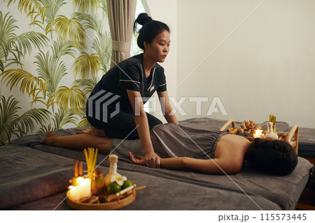 Masseuse Giving Thai Massage Masseuse Giving Thai Massage 115573445