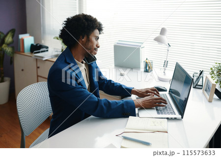 Black Businessman Working on Laptop Black Businessman Working on Laptop 115573633