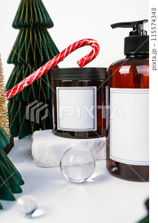 dark jar with lid and dispenser on the background of Christmas decorations, side view 115574348