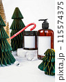 dark jar with lid and dispenser on the background of Christmas decorations, side view 115574375