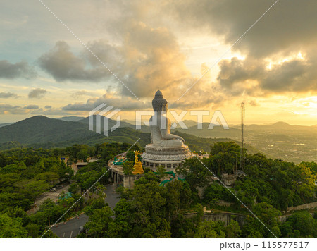 aerial view bright yellow sun at horizon in sunrise at Phuket big Buddha. aerial view bright yellow sun at horizon in sunrise at Phuket big Buddha. 115577517