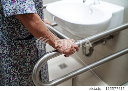 Asian elderly old woman patient use toilet support rail in bathroom, handrail safety grab bar, security in nursing hospital. Asian elderly old woman patient use toilet support rail in bathroom, handrail safety grab bar, security in nursing hospital. 115577615