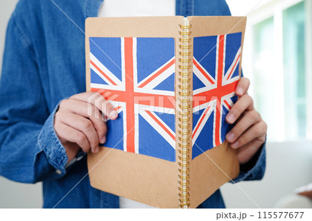 Learning English, Asian teenage student holding book with flag for language program education. Learning English, Asian teenage student holding book with flag for language program education. 115577677