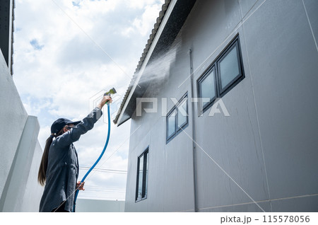 Female engineer using hose for testing window leak by spray water. Home inspection concepts. The home inspection is your last chance to uncover defects with the house. Female engineer using hose for testing window leak by spray water. Home inspection concepts. The home inspection is your last chance to uncover defects with the house. 115578056