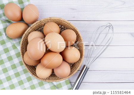 Organic chicken eggs and egg whisk Organic chicken eggs food ingredients. 115581464