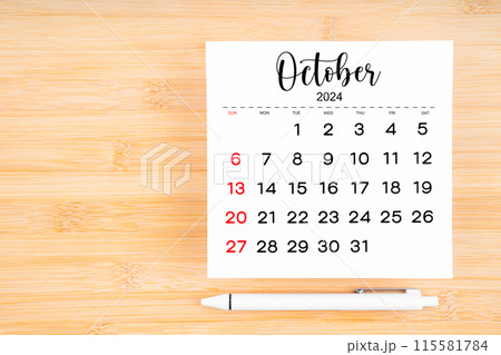 October 2024 calendar page and pen on wooden background. October 2024 calendar page and pen on wooden background. 115581784