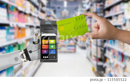 Cashless payment with robot hand holding credit card reader with credit card 115585522