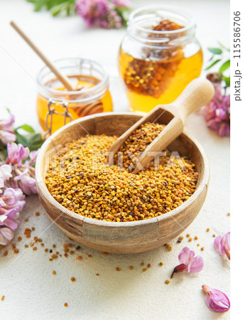 Raw organic bee pollen and honey in jars and acacia flowers. . Raw organic bee pollen and honey in jars and acacia flowers. . 115586706