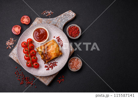 Delicious baked lasagna pasta with meat, sauce, salt, spices and herbs on a dark concrete background Delicious baked lasagna pasta with meat, sauce, salt, spices and herbs on a dark concrete background 115587141