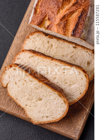 A loaf of brown bread with grains of cereals 115587281