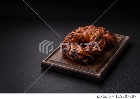 Delicious fresh baked bun with poppy seeds and berries 115587297