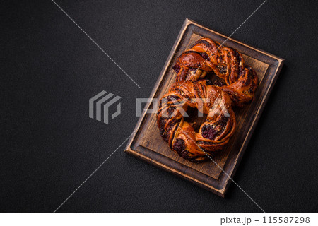 Delicious fresh baked bun with poppy seeds and berries 115587298