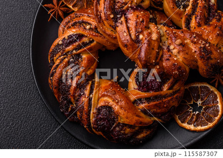 Delicious fresh baked bun with poppy seeds and berries 115587307