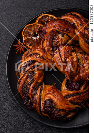 Delicious fresh baked bun with poppy seeds and berries 115587308