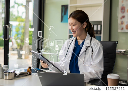 Doctor working on laptop computer, writing prescription clipboard with record information paper folders on desk in clinic, Healthcare and medical concept. Doctor working on laptop computer, writing prescription clipboard with record information paper folders on desk in clinic, Healthcare and medical concept. 115587431