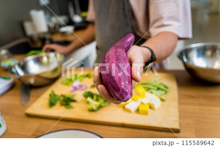 Chef at the kitchen preparing green curry with herbs and rice Chef at the kitchen preparing green curry with herbs and rice 115589642