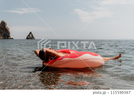 Summer Vacation Woman floats on an inflatable donut mattress, a water toy swim ring. Positive happy woman relaxing and enjoying family summer travel holidays vacation on the sea. Slow motion Summer Vacation Woman floats on an inflatable donut mattress, a water toy swim ring. Positive happy woman relaxing and enjoying family summer travel holidays vacation on the sea. Slow motion 115590367