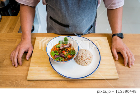 Chef at the kitchen preparing massaman curry with sweet potato and many spices 115590449