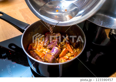 Chef at the kitchen preparing massaman curry with sweet potato and many spices 115590457