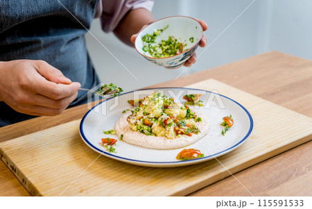 Chef at the kitchen preparing bean porridge with cauliflower and vegetables Chef at the kitchen preparing bean porridge with cauliflower and vegetables 115591533