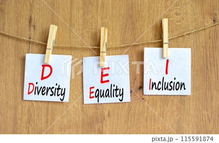 DEI diversity equality inclusion symbol. Concept words DEI diversity equality inclusion on beautiful paper. Beautiful wooden background. Business DEI diversity equality inclusion concept. Copy space. 115591874