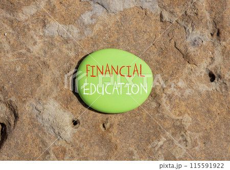 Financial education symbol. Concept words Financial education on beautiful green stone. Beautiful red stone background. Business Financial education concept. Copy space. 115591922
