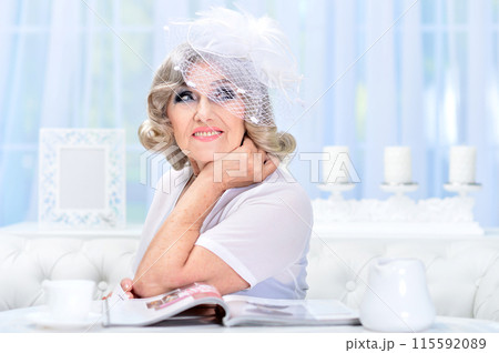 Portrait of happy senior woman posing at home Portrait of happy senior woman posing at home 115592089