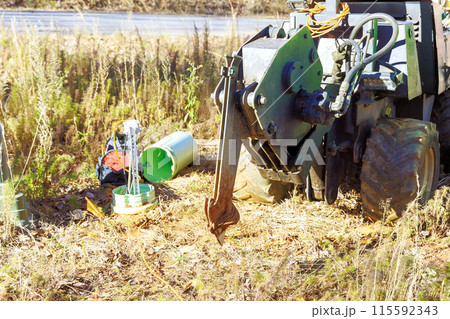 Fiber optic cables laid with help of trencher cable plow tractor Fiber optic cables laid with help of trencher cable plow tractor 115592343