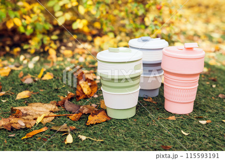 Environmental-friendly collapsible cups or foldable cup made from Silicone with green grass and fallen leaves in autumn background Environmental-friendly collapsible cups or foldable cup made from Silicone with green grass and fallen leaves in autumn background 115593191