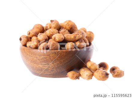 Tiger nuts in wooden bowl, isolated on white background. Pile of chufa nuts, earth almond or chufa sedge. Cyperus esculentus. 115595623