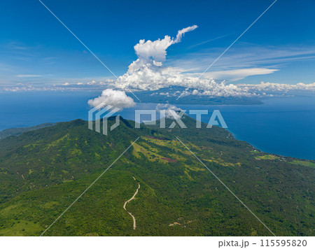 Mountain landscape with green hills and forest. Blue sky and clouds. Camiguin Island. Philippines. 115595820